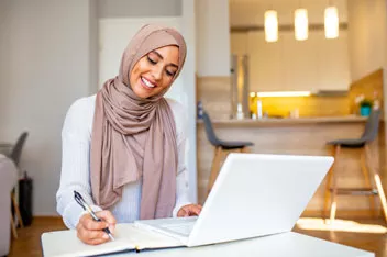 A professional woman works remotely with confidence, representing the flexibility and convenience of a Servcorp virtual office in Saudi Arabia.