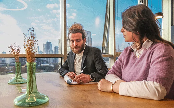 Coworking Space at Qubic Square with clients working and collaborating in an open hot desk area.